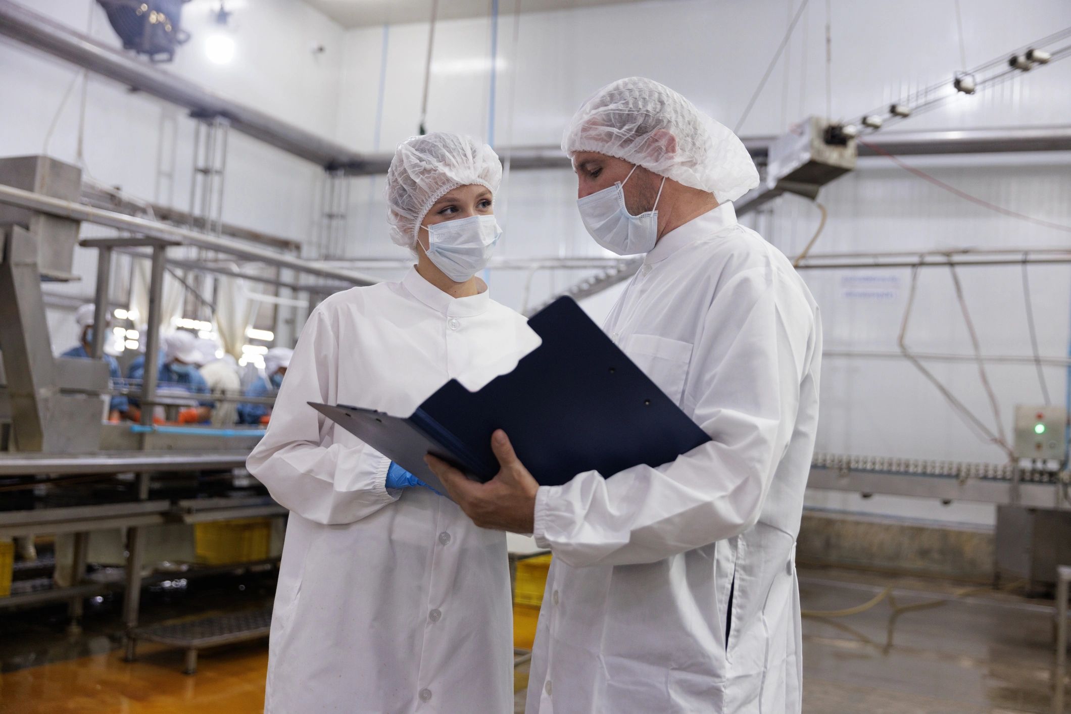 Factory supervisors reviewing quality procedures