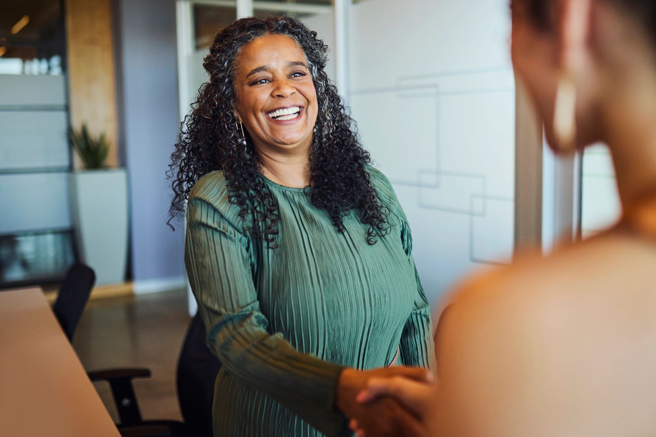 Business partners shaking hands to confirm an agreement